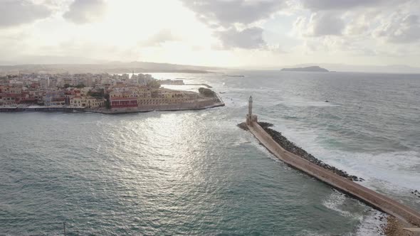 Epic Aerial Drone footage of lighthouse in the old Venetian port of Chania. Cinematic sunset shot.