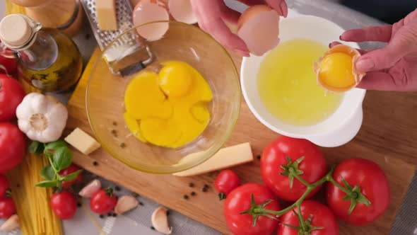 Making Pasta Carbonara  Pouring Crushed Egg Yolk Into Glass Bowl