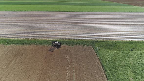 Aerial View of Amish Farm Worker Harvesting Spring Crop With Team of 6 Horses