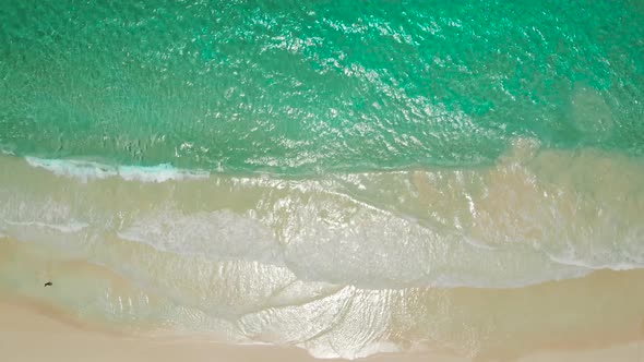 Beach and Azure Sea with Waves From Top View