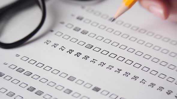 Crop Student Doing Test on Table