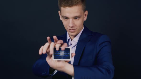 The Magician Shows Tricks with Playing Cards