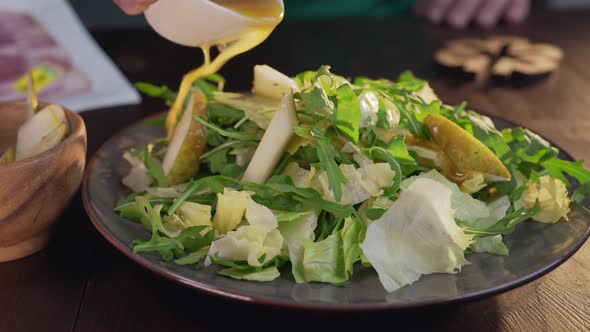 Chef Adds Some Sauce To the Salad with Greens and Vegetables, Vegetarian Meal, Vitamins and Healthy