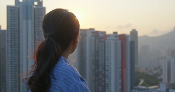 Woman Look at The Apartment Building in City