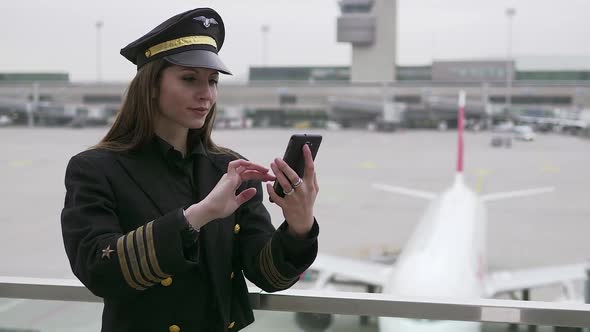 Portrait of Female Pilot Officer in Uniform at Airport