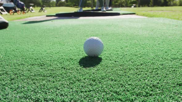 Low section of senior man practicing golf at golf course on a bright sunny day