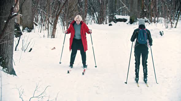 A Blonde Woman Walking on Ski in the Woods