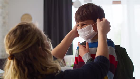 Video of mother puts on a protective mask for son. Shot with RED helium camera in 8K.