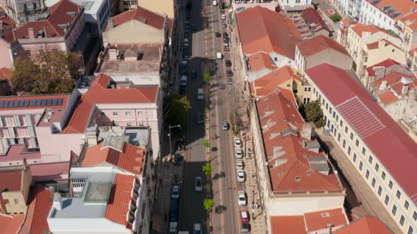 Aerial Dolly in Reveal of Multi Lane Road Traffic Through Lisbon City Center Surrounded By