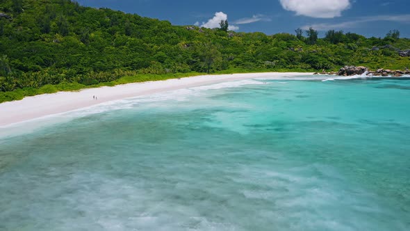 Aerial View of Tropical Paradise Beach Anse Coco with Wide Blue Lagoon