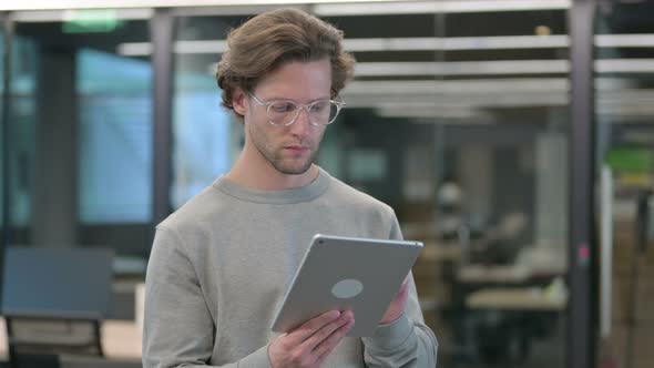 Portrait of Young Businessman Using Digital Tablet