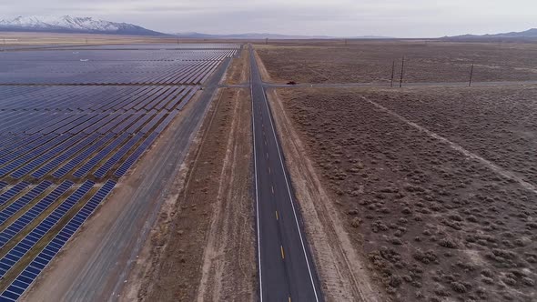 Flying over road parallel with solar farm in the Utah desert
