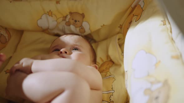 Cute Baby Lying in His Crib