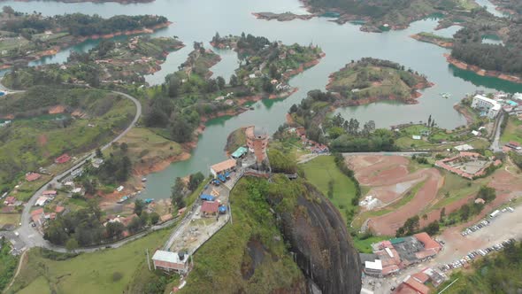 Flying above a large granite rock called The Rock of Guatape in Antioquia, Colombia - aerial drone s