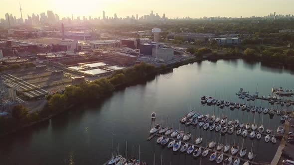 Aerial Sunset Wide Shot Rising Over Lake Ontario Sailboat Yacht Marina Dock With Industrial Factory