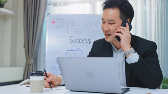 Happy entrepreneur businessman in formal wear work on laptop computer in office with smile in office