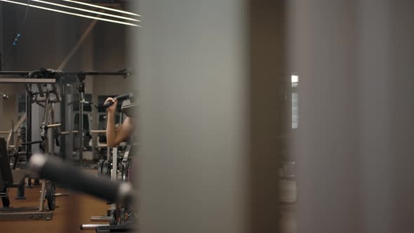 Camera Flight From Right to Left a Woman Doing Squats with a Load