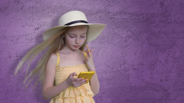 Girl Posing with Mobile Phone on Violet Background