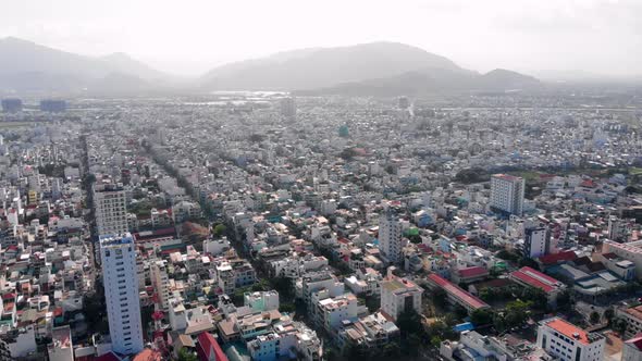 Flying Drone in an Early Sunny Morning Over a City with a Lot of Smoke Smoke From City Cars and