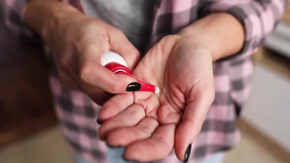 Slow motion of Female hands care, woman applying cream on hand skin