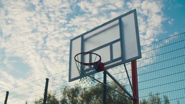 Streetball Player Dunking on Outdoor Court at Dawn