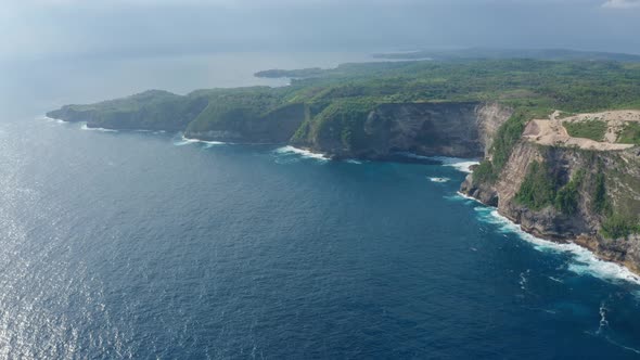 Aerial View of Kelingking Beach in Nusa Penida Island Azure Ocean Mountains