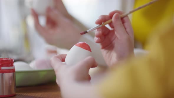 Close up of Unrecognizable People Decorating Easter Eggs
