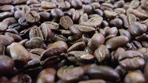 Closeup of Falling Roasted Brown Coffee Beans in Slow Motion