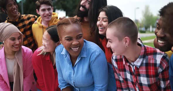 Group of young multiracial people having fun together in the city