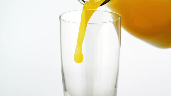 Pouring orange juice into glass, Slow Motion