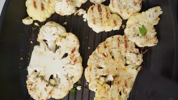 Cauliflower Steak with Spices Cooks on a Grill Pan in Closeup