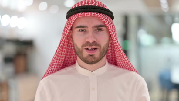 Portrait of Positive Arab Businessman Saying Yes By Shaking Head