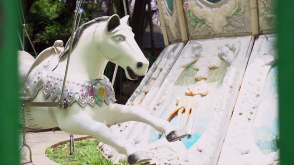 Close-up of a white carousel horse in an amusement park
