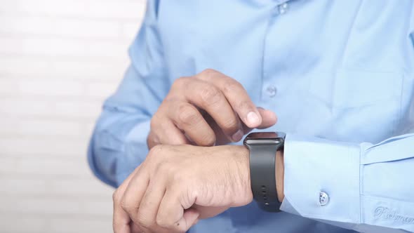 Man's Hand Using Smart Watch