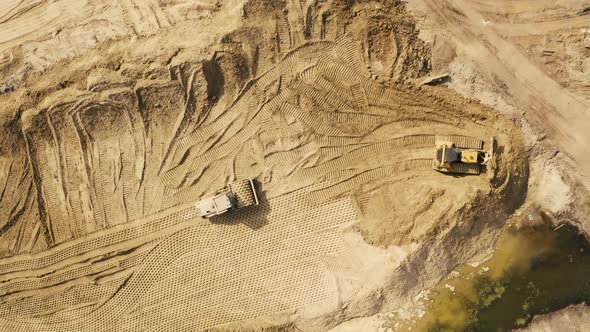 Aerial photo of a steam roller and a bulldozer on a construction site