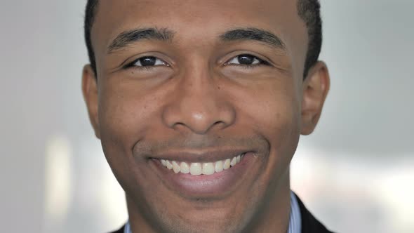 Close Up of Smiling Face of Casual Afro-American Businessman Looking at Camera