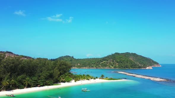 Aerial seascape of tranquil shore beach journey by blue ocean and bright sandy background of a dayou