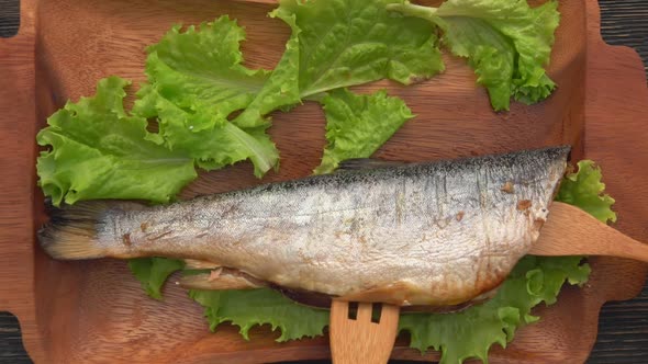 The Top View of the Juicy Grilled Red Char Fish Opened with a Bamboo Fork