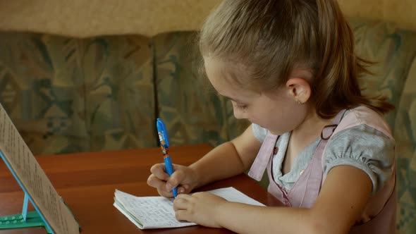 A Cute Little Girl is Doing Her Homework