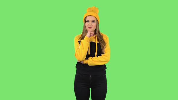 Modern Girl in Yellow Hat Is Focused Thinking About Something, No Idea. Green Screen