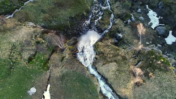 Aerial video of a waterfall along the Klausen Pass in Switzerland.