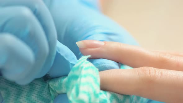 Manicurist in Gloves Cut the Cuticle To the Client.