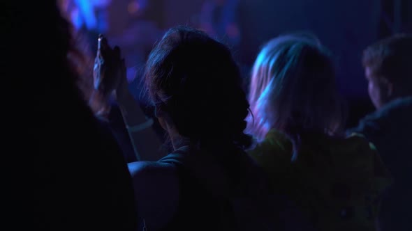 People Raising Their Hands and Singing Songs