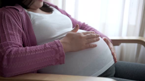 Happy Pregnant Woman and Expecting Baby at Home