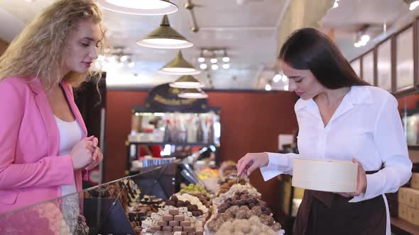 Woman At Chocolate Store Buying Handmade Sweets