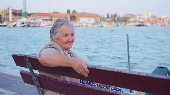 Elderly Woman Enjoys Seascape By Lagoon in Chioggia