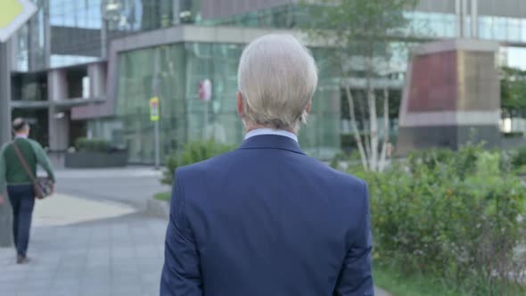 Back View of Walking Old Businessman