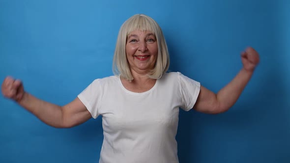Healthy Mature Senior 50s Woman Showing Arms with Plaster After Vaccine Celebrating a Victory Over