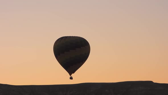 Hot Air Balloon Rising and Flying at Sunrise Morning