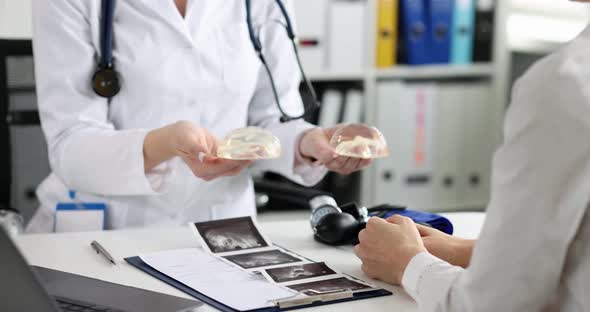 Female Plastic Surgeon Shows Silicone Breast Implant to Patient